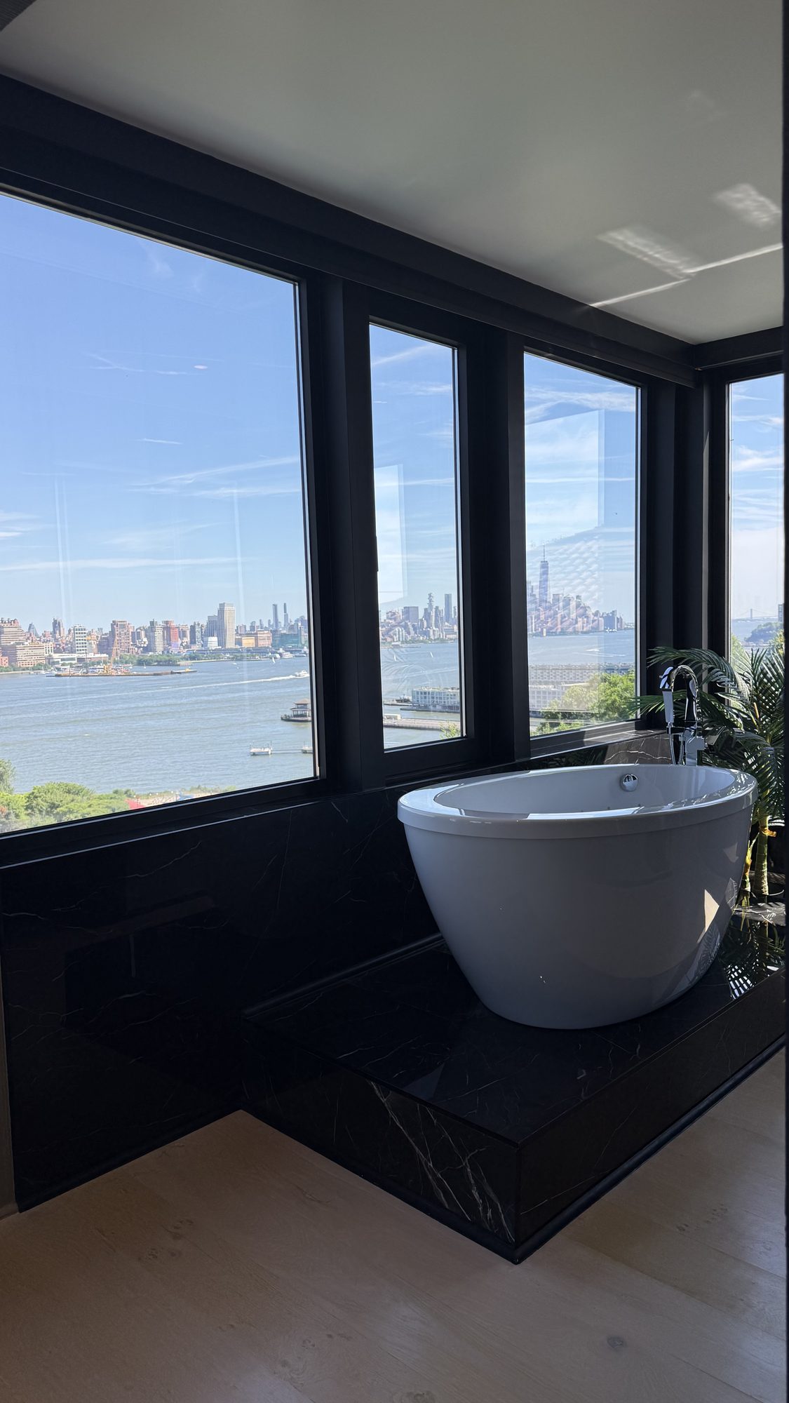 Marble bathroom with freestanding tub and skyline view