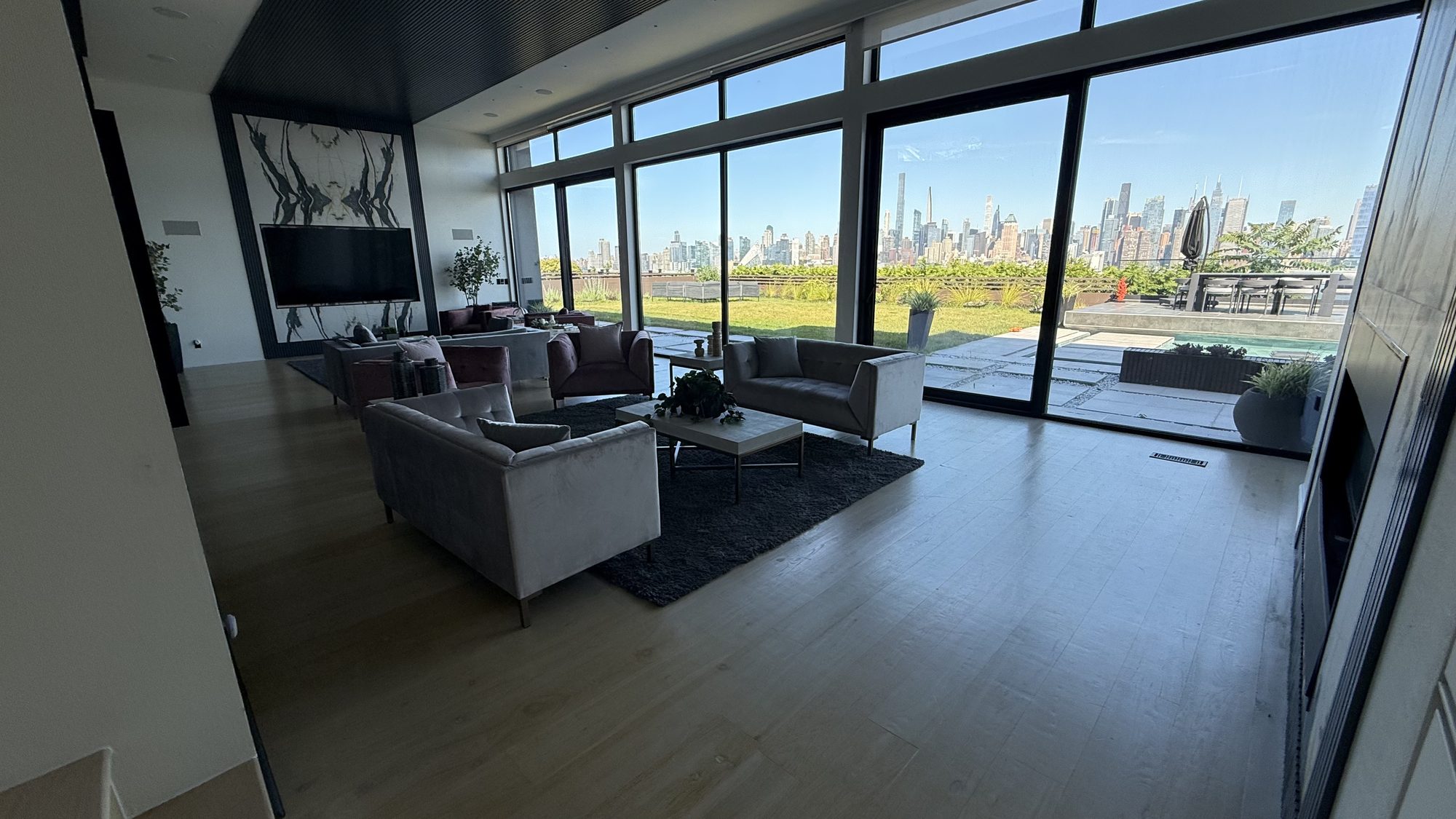 Great room with floor-to-ceiling skyline windows